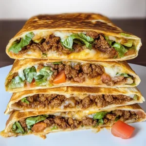 Keto crunchwrap filled with seasoned ground beef, cheese, lettuce, and low-carb tortilla, folded and grilled to perfection.