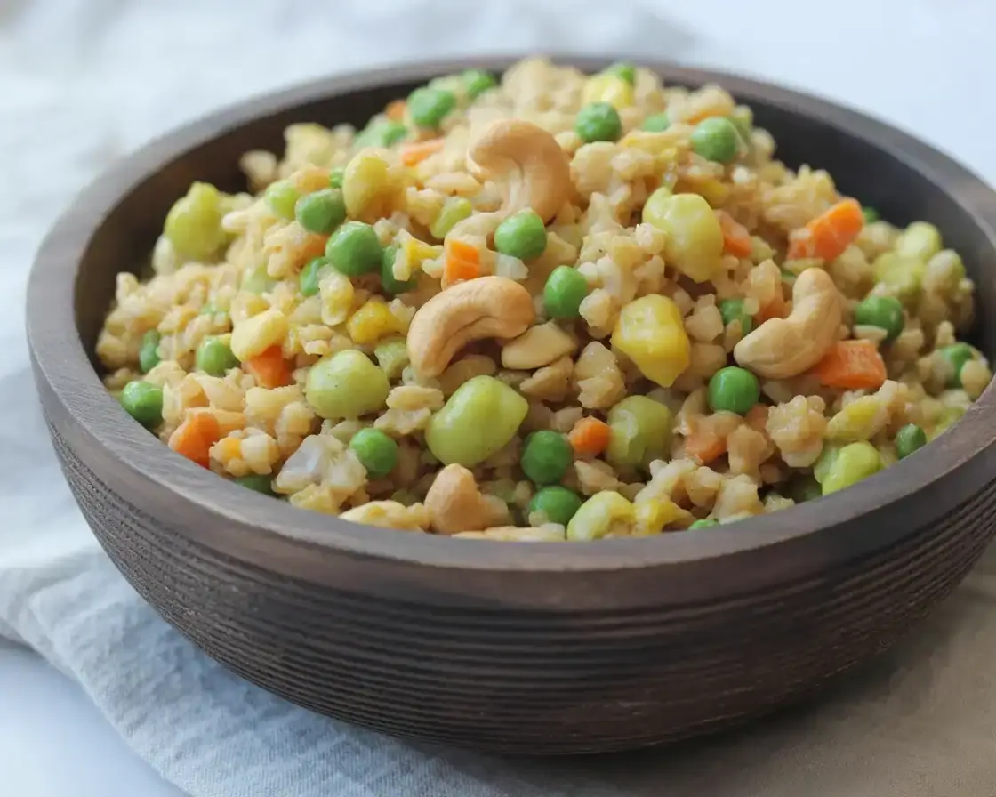 Healthy cauliflower fried rice with vegetables and eggs served in a bowl.