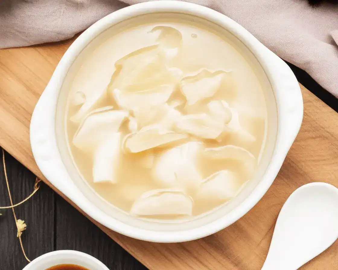 Bowl of rich and silky fish maw soup with crab meat and herbs